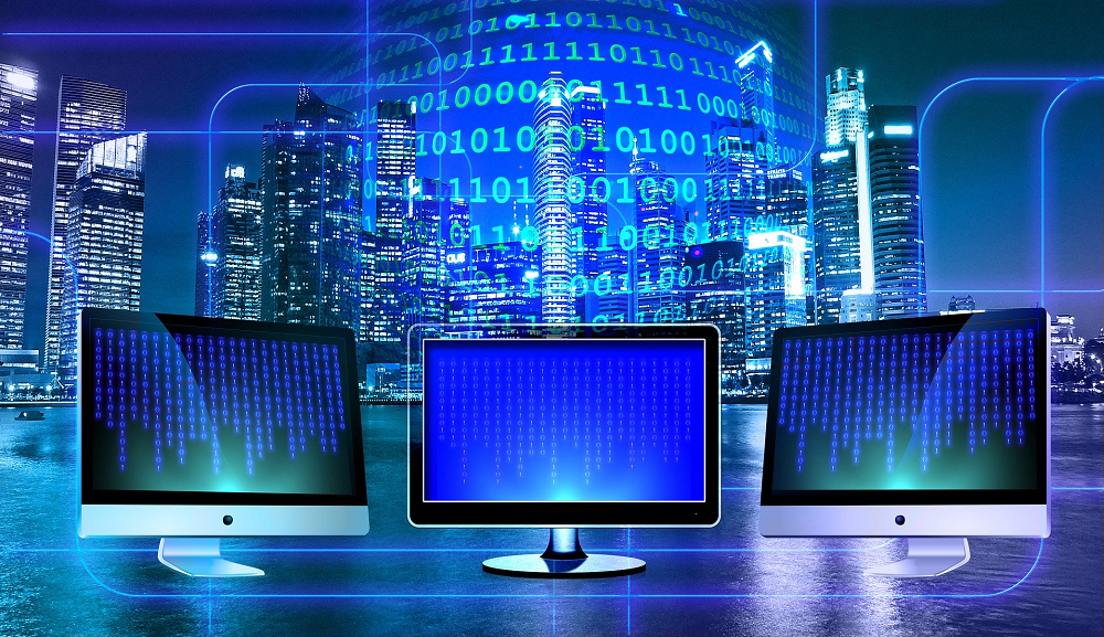 Three monitors in front of a window showing a city skyline and overlaid by binary code-SkyViewTek Managed IT Services Three monitors in front of a window showing a city skyline and overlaid by binary code-SkyViewTek Managed IT Services